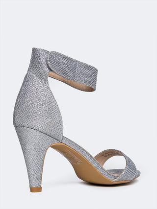Silver glitter heels by J.Adams featuring a sleek design with sparkling embellishments and elegant pointed toes.