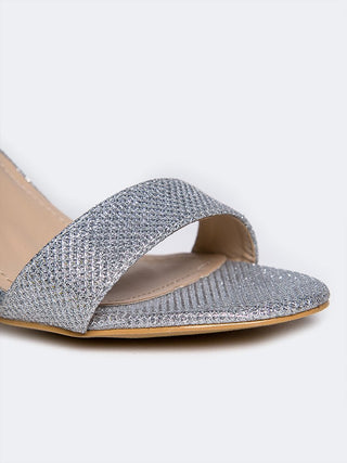 Silver glitter heels by J.Adams featuring a sleek design with shiny, sparkling details, perfect for stylish occasions.